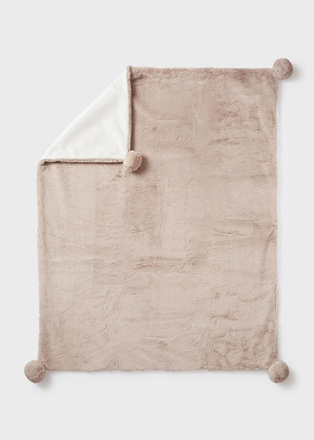 Coperta in pelliccia con pon pon